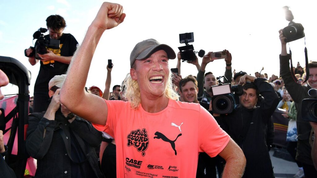 Nedd Brockmann crossing the finish line at Bondi Beach after running Melbourne to Sydney raising $2.5 million for We Are Mobilise 2022